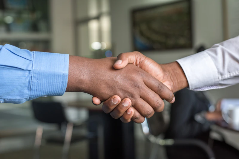 Attorney and client shaking hands after agreeing to representation